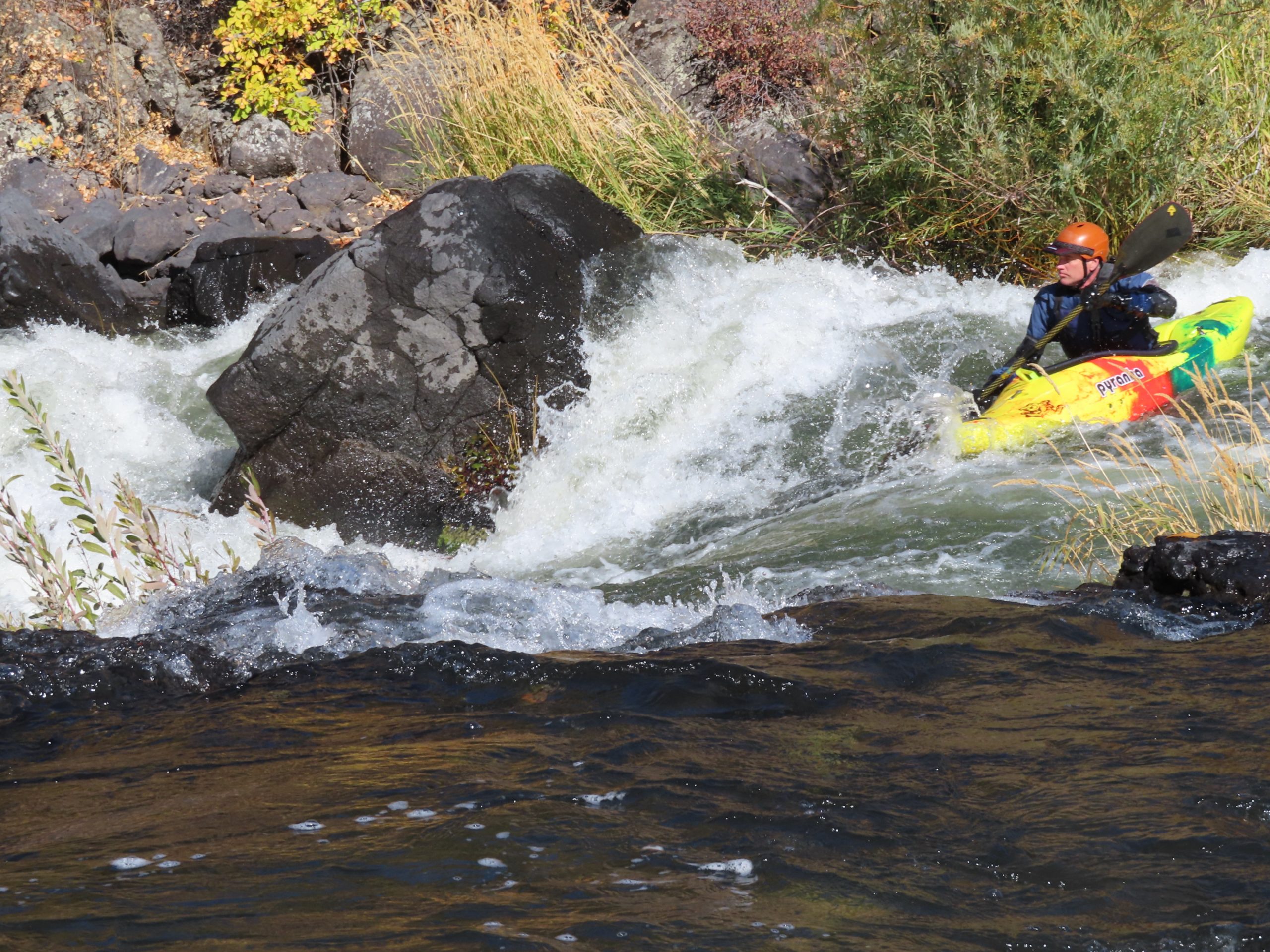 Kayaker going through rapid